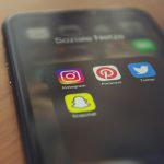 Smartphone displaying popular social media apps like Instagram, Pinterest, Twitter, and Snapchat.